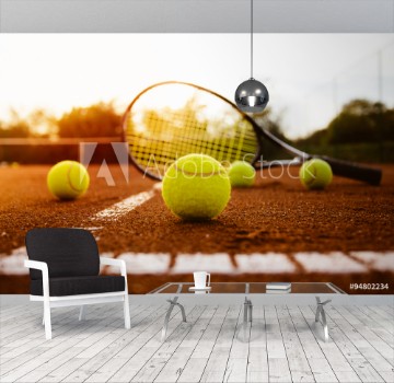 Picture of Tennis balls with racket on clay court